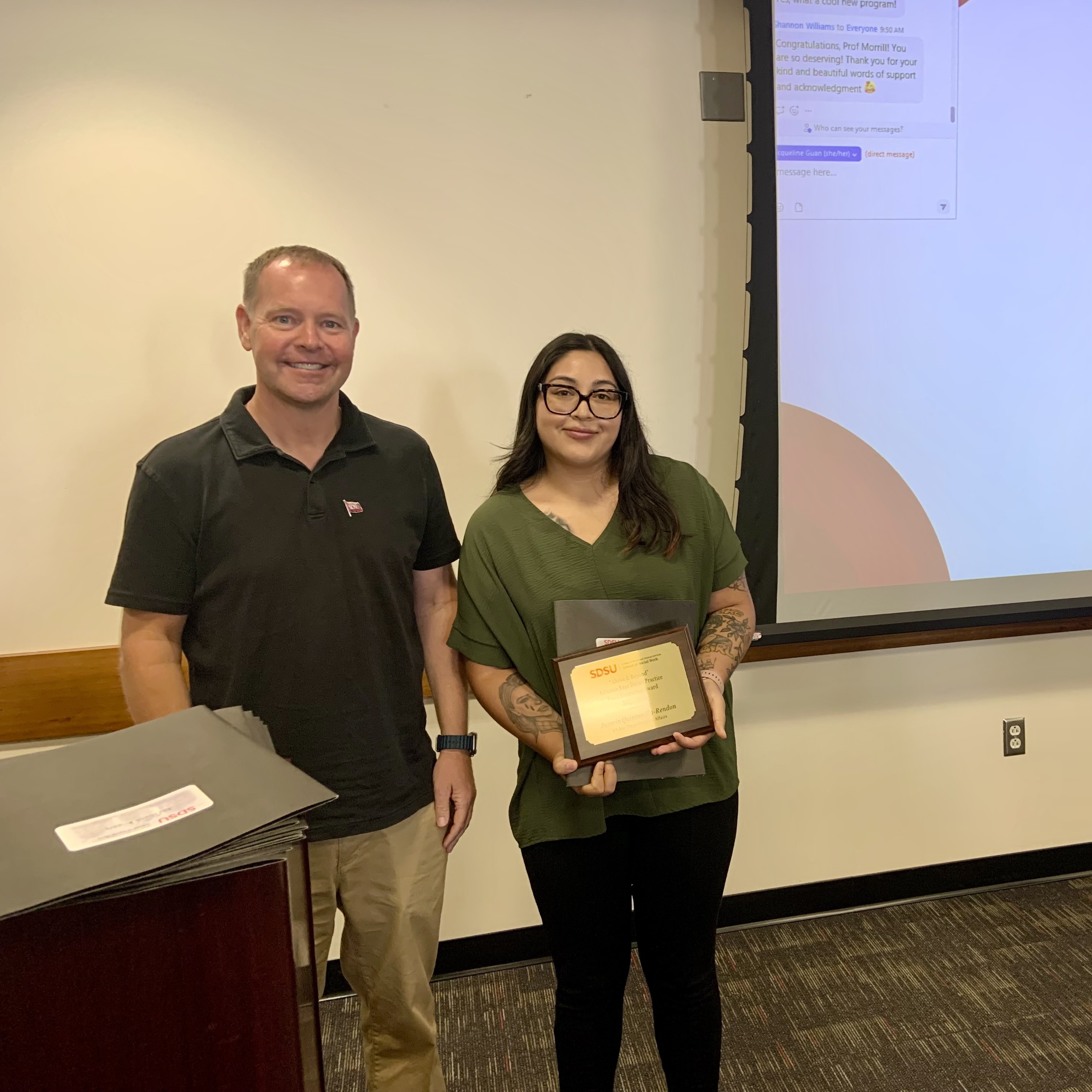 Professor and student with award